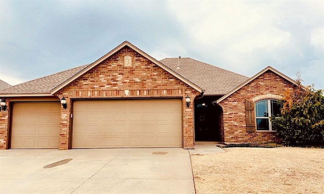 ranch-style house with an attached garage, a shingled roof, concrete driveway, and brick siding