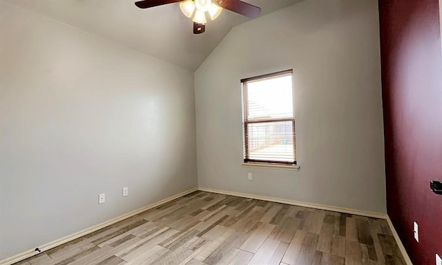 empty room with a ceiling fan, lofted ceiling, baseboards, and light wood finished floors