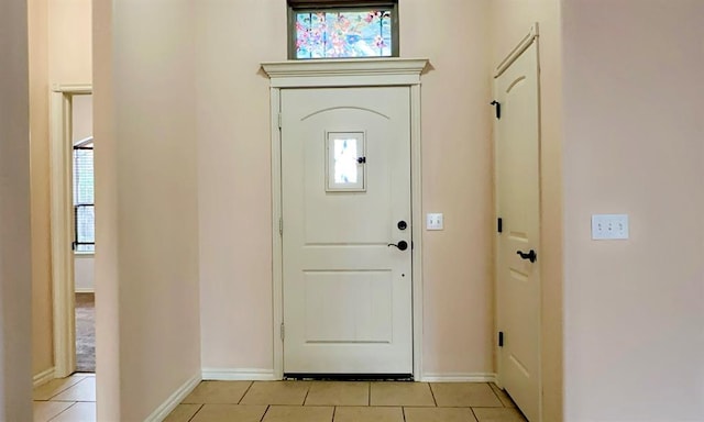 entryway featuring light tile patterned floors and baseboards