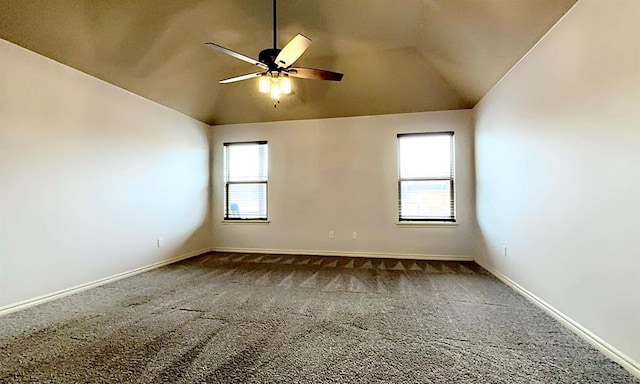 carpeted spare room with a ceiling fan, lofted ceiling, and baseboards