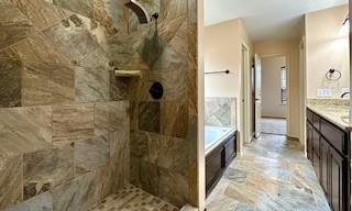 full bath with a garden tub, a tile shower, and vanity