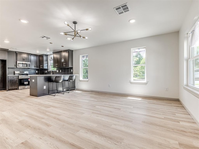 kitchen featuring stainless steel appliances, plenty of natural light, and visible vents