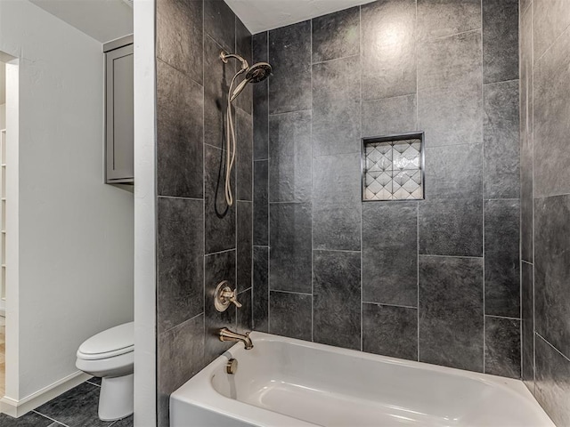 bathroom featuring toilet, tile patterned flooring, and tub / shower combination