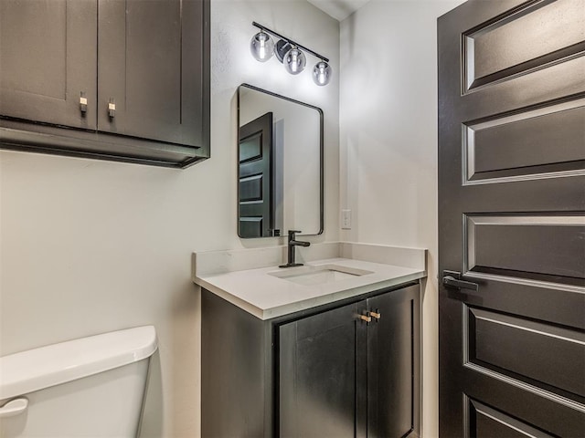 bathroom featuring toilet and vanity