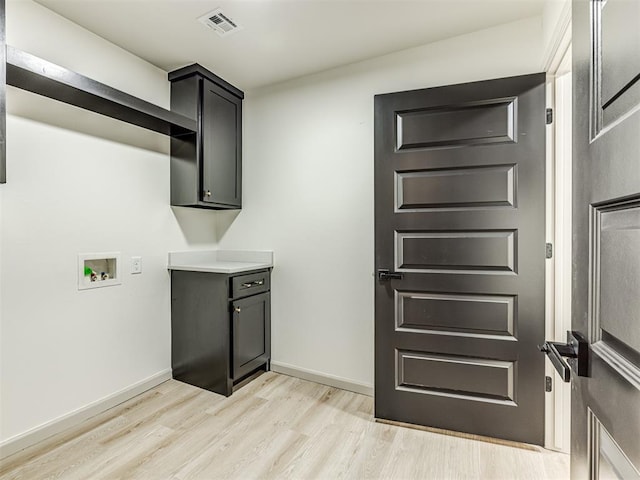 laundry room featuring visible vents, baseboards, light wood-type flooring, cabinet space, and hookup for a washing machine