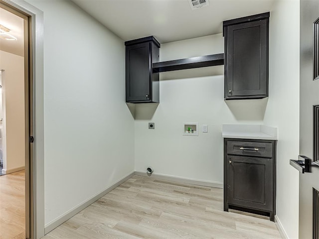 washroom featuring visible vents, hookup for an electric dryer, light wood finished floors, cabinet space, and hookup for a washing machine