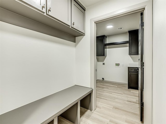mudroom with light wood-style floors and visible vents