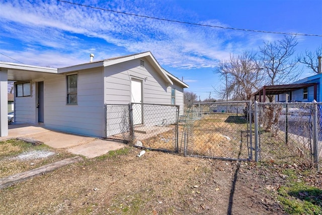 view of side of property featuring a gate and fence