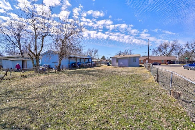 view of yard with an outdoor structure and fence