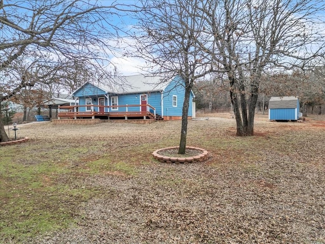 view of yard featuring a deck, a storage unit, and an outbuilding