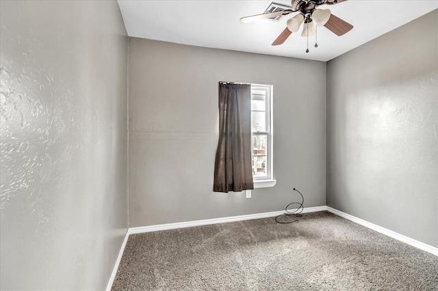 spare room with a ceiling fan, carpet, and baseboards