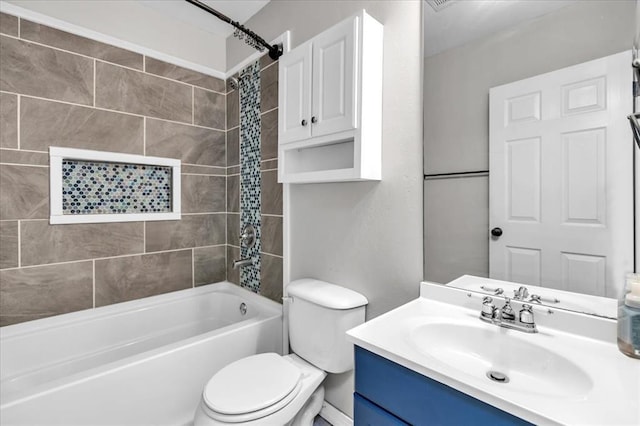 full bathroom featuring toilet, bathing tub / shower combination, and vanity