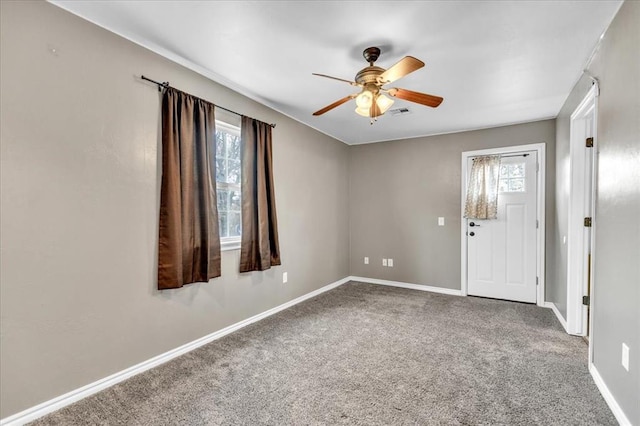 spare room featuring carpet, baseboards, and ceiling fan