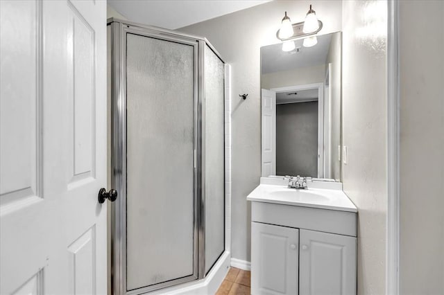 bathroom featuring a shower stall, vanity, and tile patterned floors