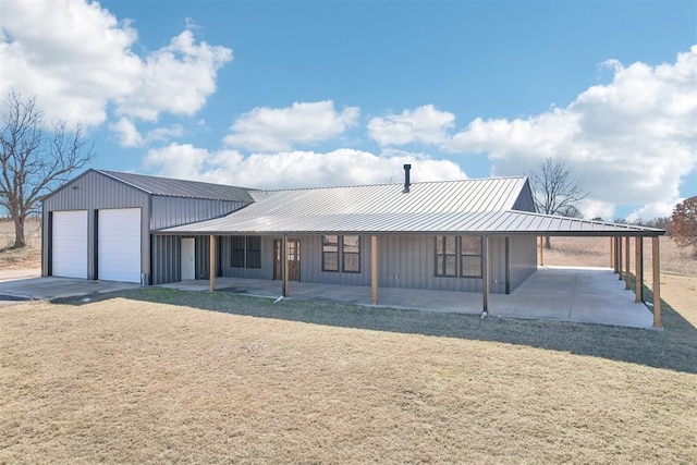 view of front of property with metal roof, a standing seam roof, an outdoor structure, a porch, and a carport