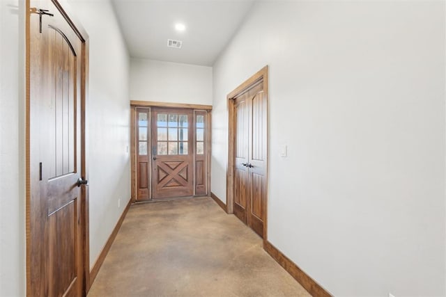 doorway with baseboards and visible vents