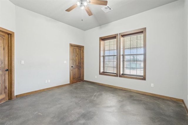 unfurnished room featuring ceiling fan, concrete floors, visible vents, and baseboards