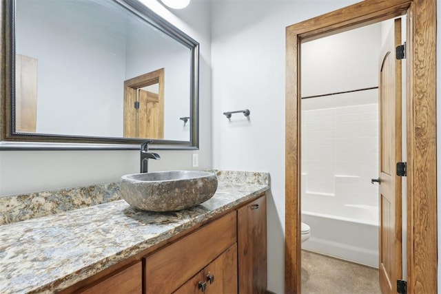 full bathroom featuring toilet, washtub / shower combination, and vanity