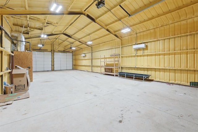 garage with metal wall and a garage door opener