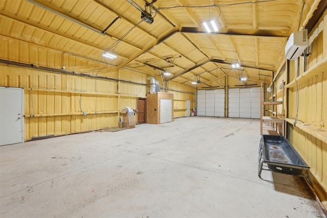 garage featuring a garage door opener and a wall mounted air conditioner