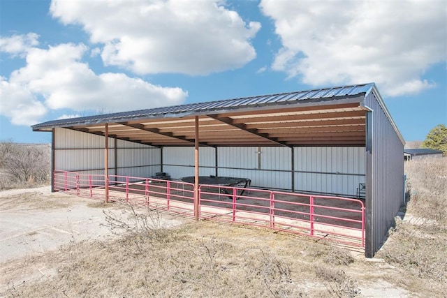 view of vehicle parking featuring an exterior structure