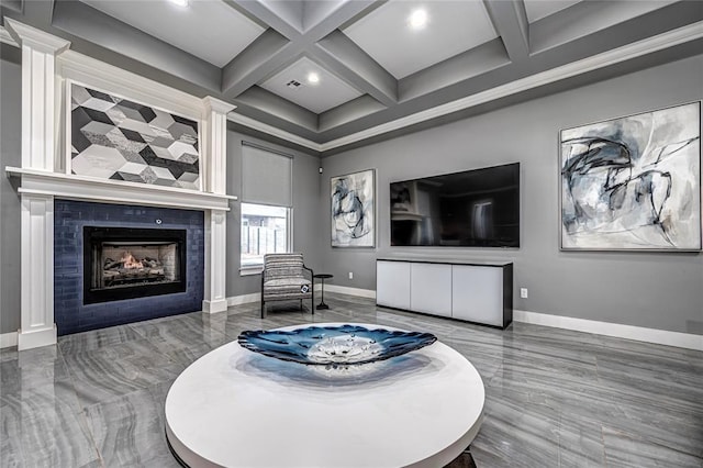 living room featuring beamed ceiling, baseboards, coffered ceiling, and a tile fireplace