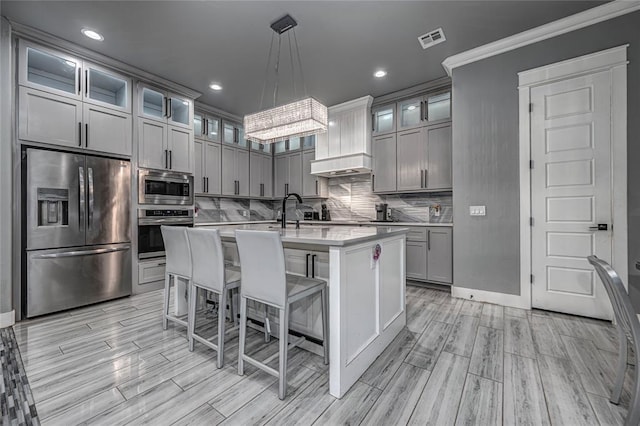 kitchen with visible vents, gray cabinetry, tasteful backsplash, appliances with stainless steel finishes, and light countertops