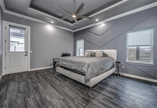 bedroom with wood finished floors, a raised ceiling, baseboards, and ornamental molding