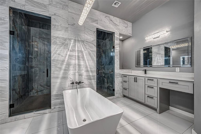 bathroom featuring vanity, visible vents, a soaking tub, a stall shower, and tile patterned flooring