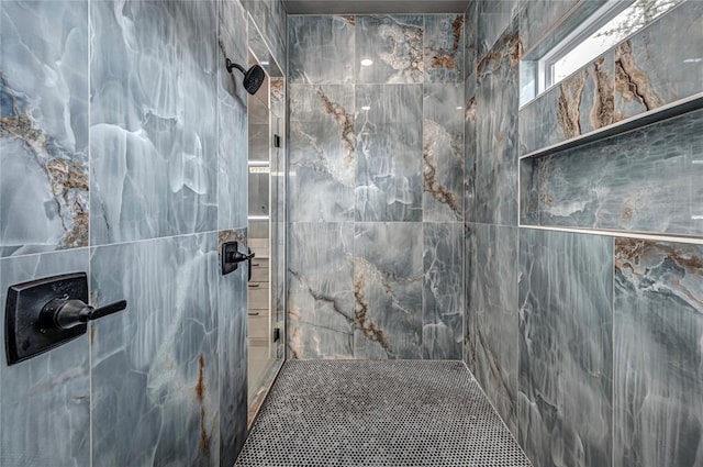 bathroom with tiled shower