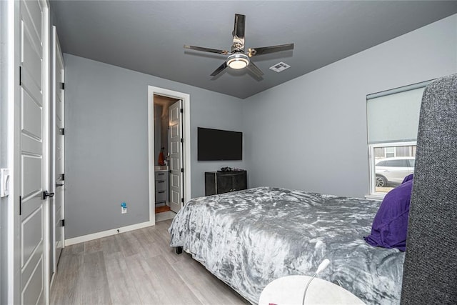 bedroom featuring ceiling fan, visible vents, baseboards, and wood finished floors