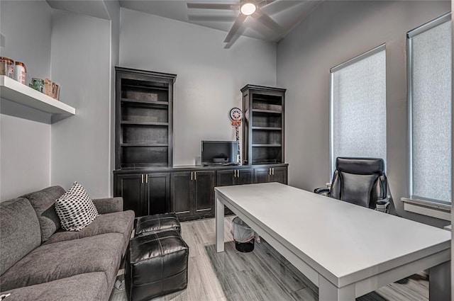 home office featuring a ceiling fan and light wood finished floors