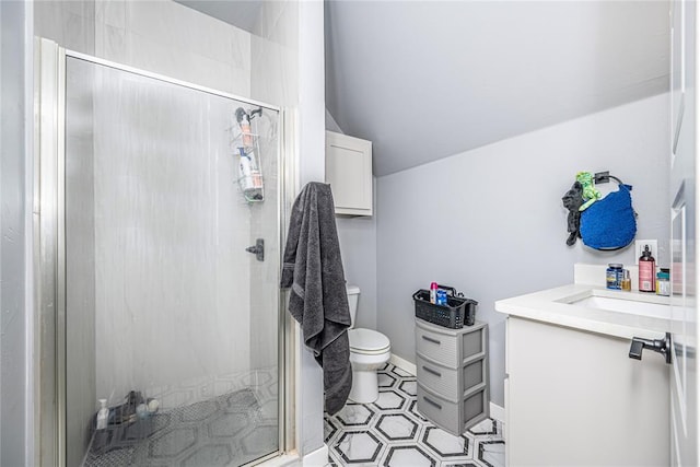 full bath featuring a shower stall, baseboards, toilet, vaulted ceiling, and vanity