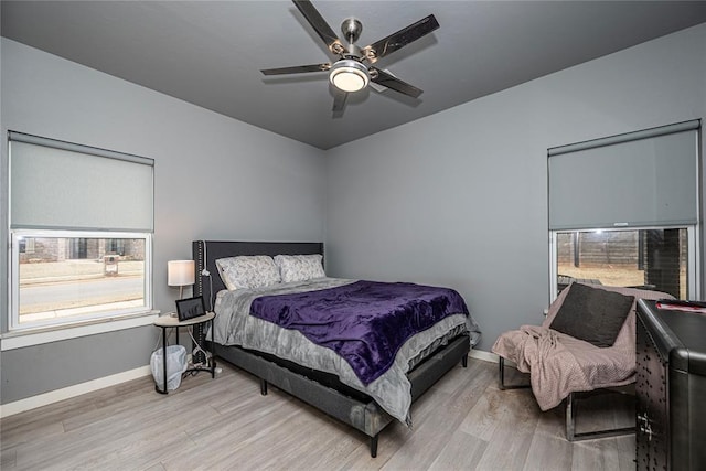 bedroom featuring a ceiling fan, wood finished floors, and baseboards