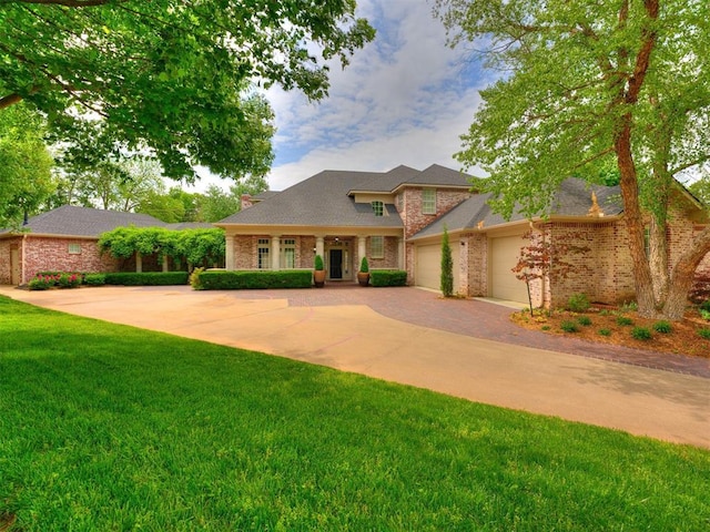 view of front facade with brick siding, a garage, decorative driveway, and a front lawn