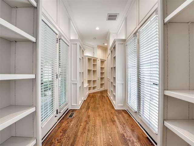 walk in closet featuring visible vents and wood finished floors