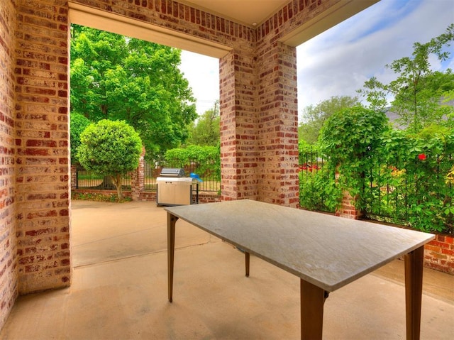 view of patio featuring fence