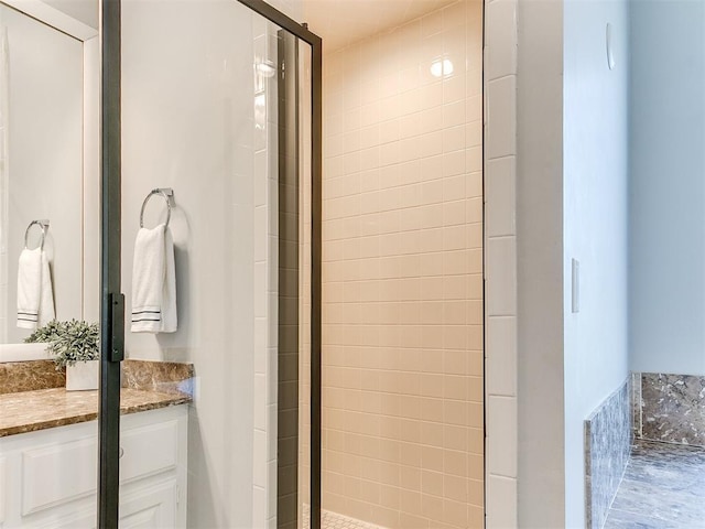 full bathroom featuring a stall shower and vanity