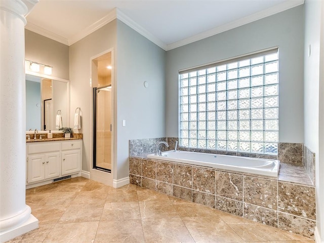 full bathroom featuring a garden tub, ornamental molding, a shower stall, decorative columns, and vanity