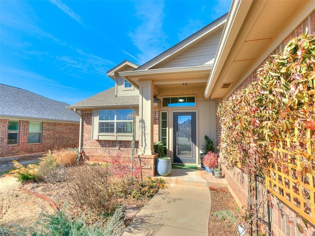 view of exterior entry with brick siding