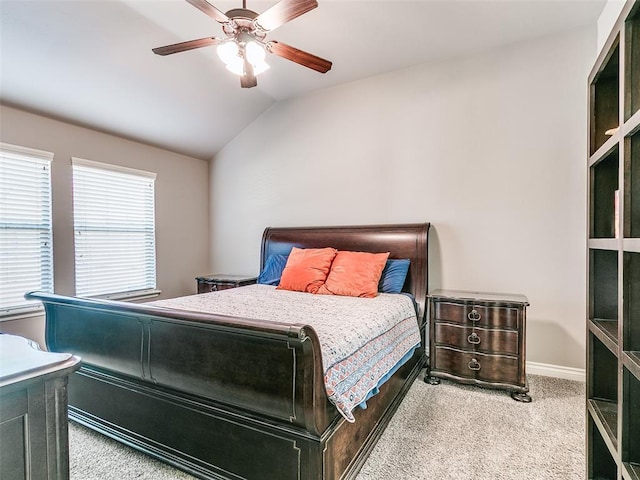 bedroom featuring a ceiling fan, lofted ceiling, light carpet, and baseboards