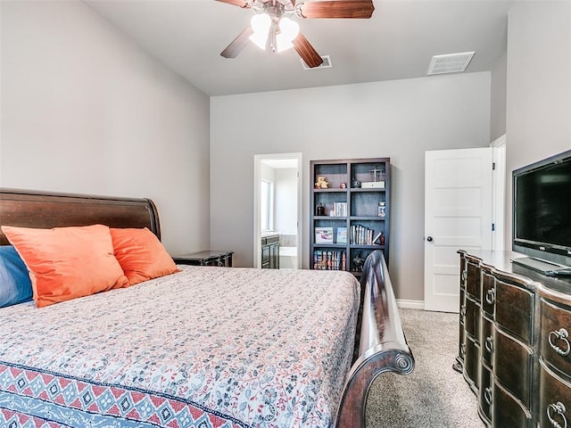 bedroom featuring carpet floors, visible vents, ensuite bathroom, ceiling fan, and baseboards