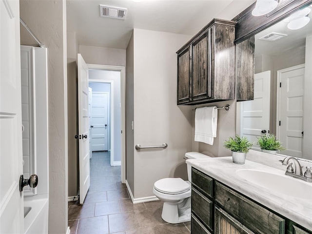 bathroom with toilet, vanity, baseboards, visible vents, and tile patterned floors