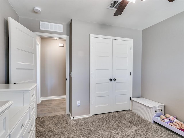 unfurnished bedroom featuring a closet, carpet flooring, visible vents, and baseboards