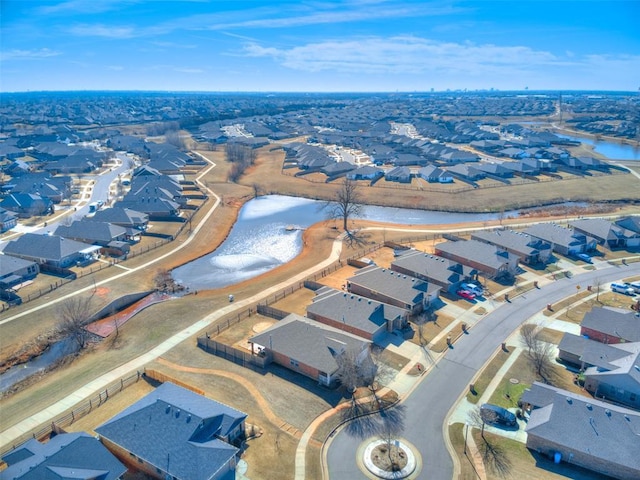 drone / aerial view with a residential view and a water view