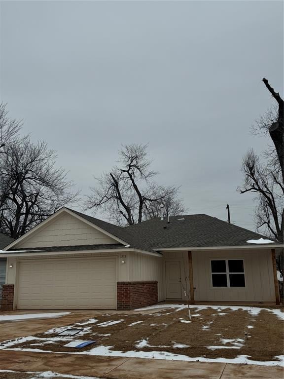 ranch-style home with a garage, brick siding, and board and batten siding