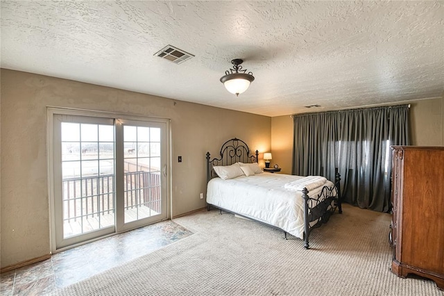 bedroom featuring access to outside, visible vents, a textured ceiling, and carpet flooring