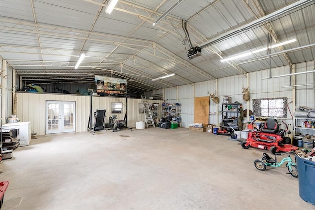 garage featuring french doors, metal wall, and a garage door opener