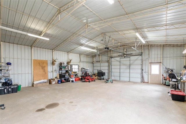 garage featuring a garage door opener and metal wall