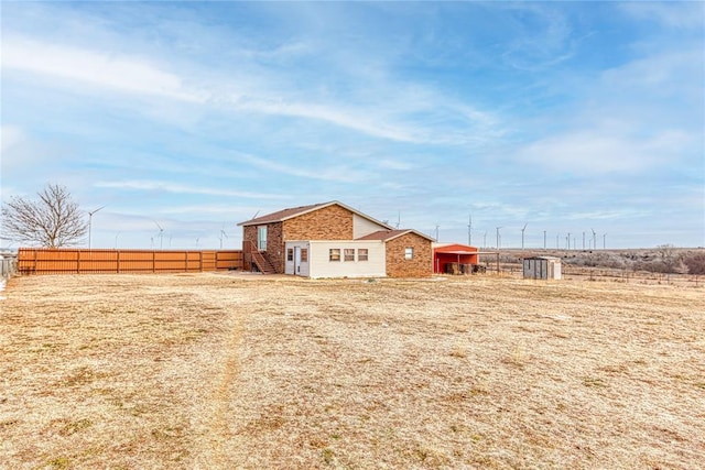 view of yard featuring a rural view and fence